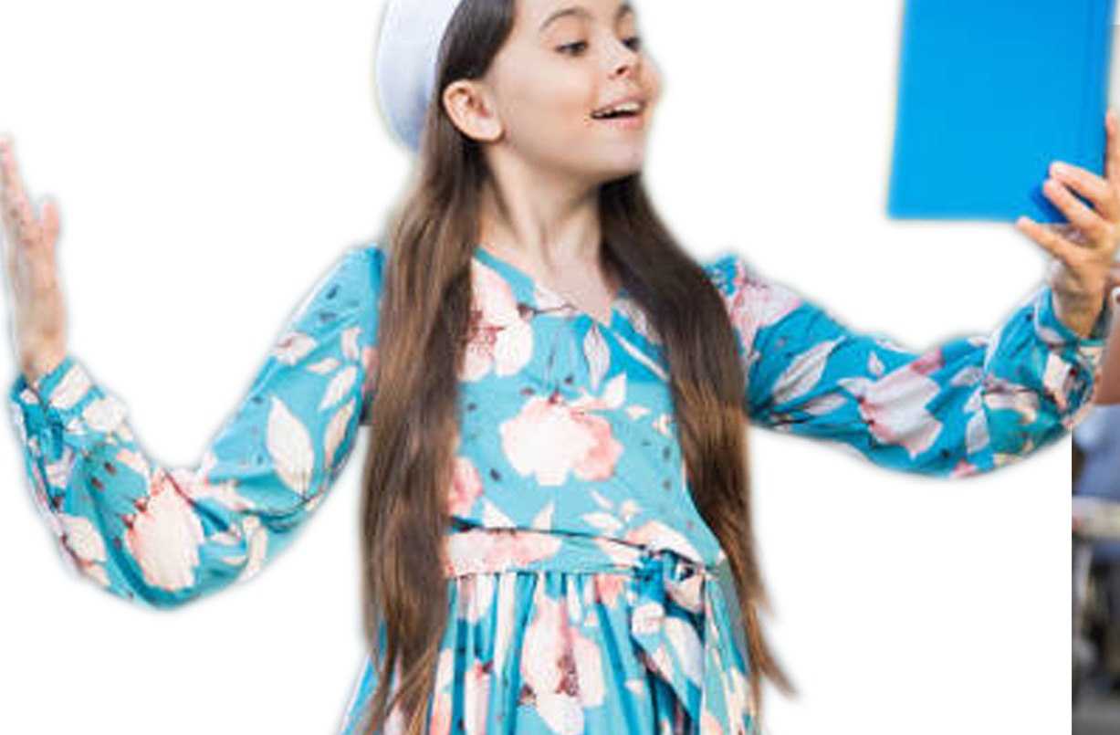 A young student expressively performing a reading, arm raised, holding a book — the confident public-speaking style LAMDA develops